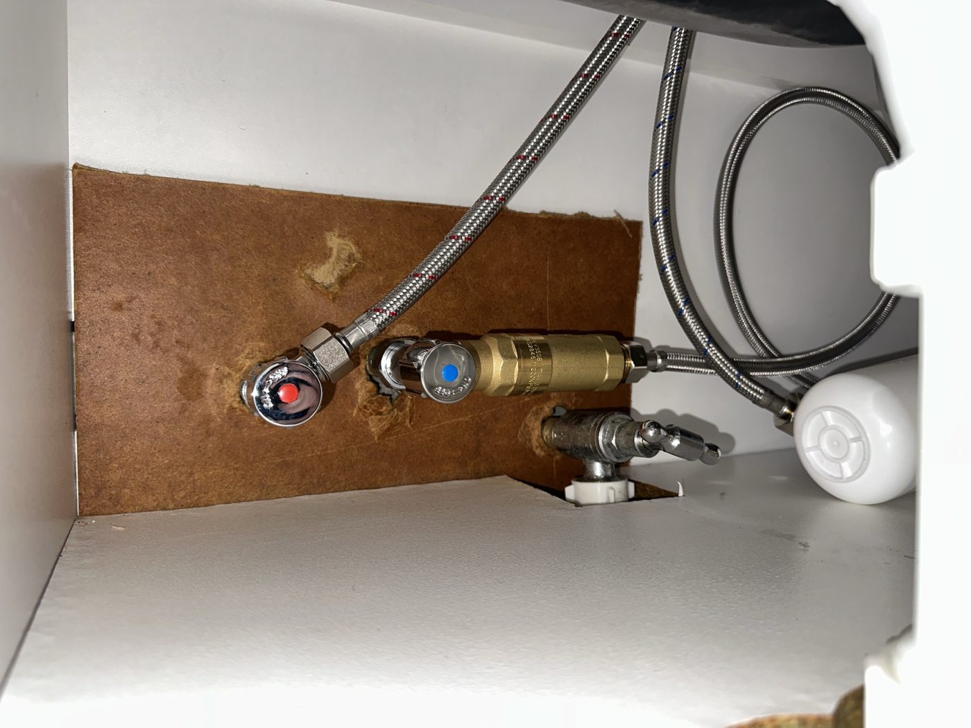 Replaced flexible hoses and isolation valves under a vanity in a Mortdale unit