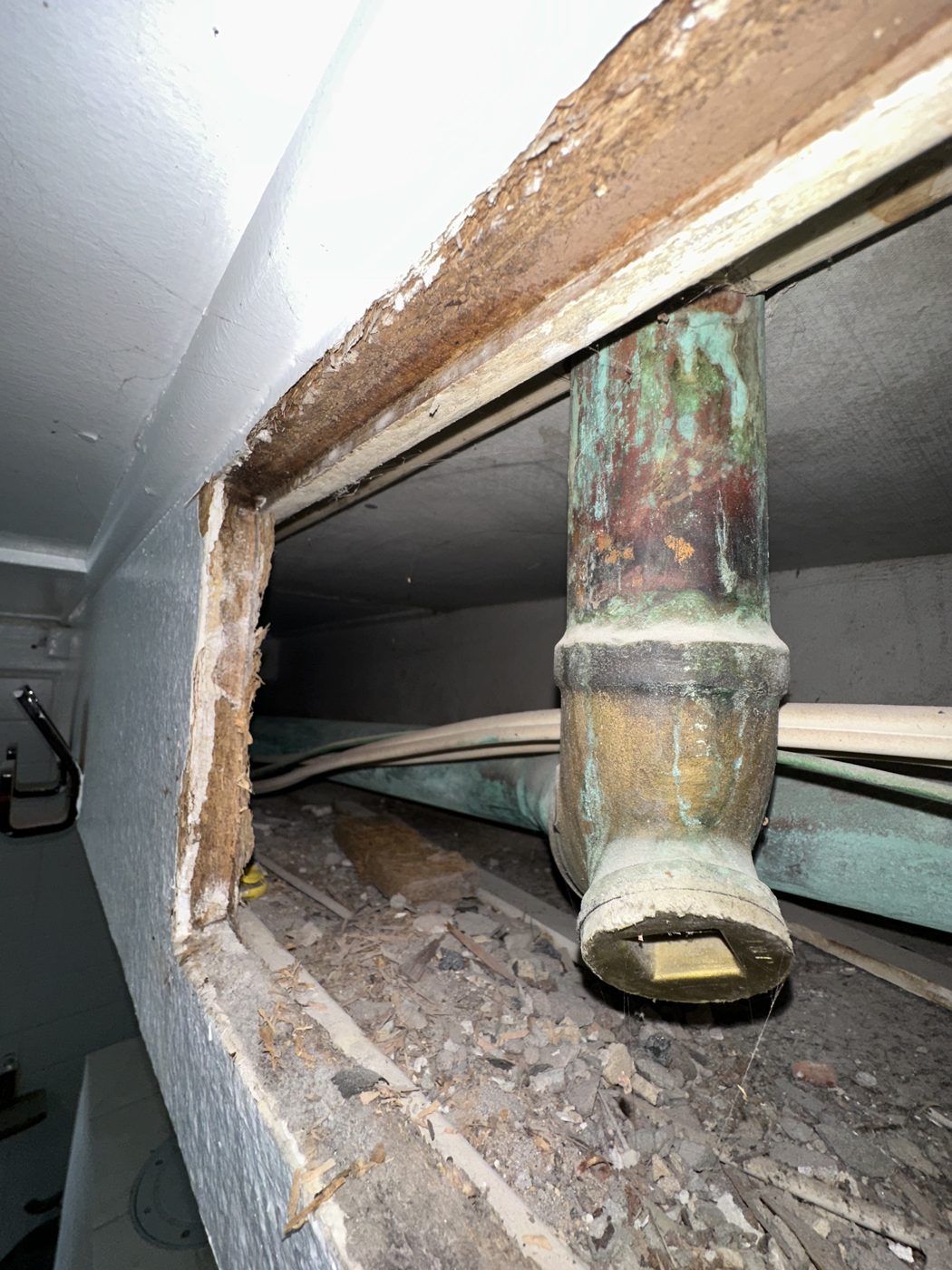 Corroded copper water pipe exposed inside an opened wall cavity in Vaucluse