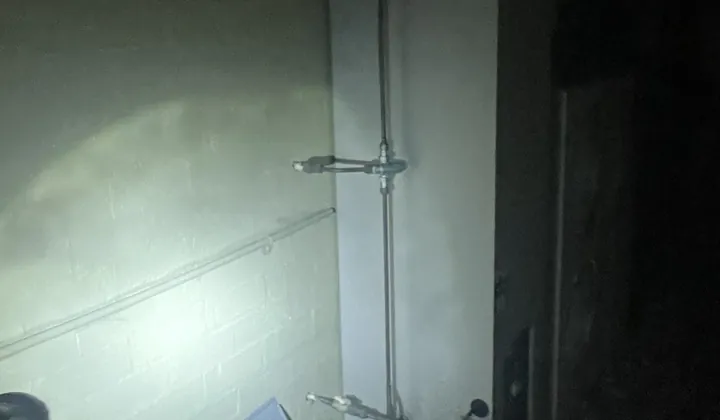 Hot water system checked by torchlight at night