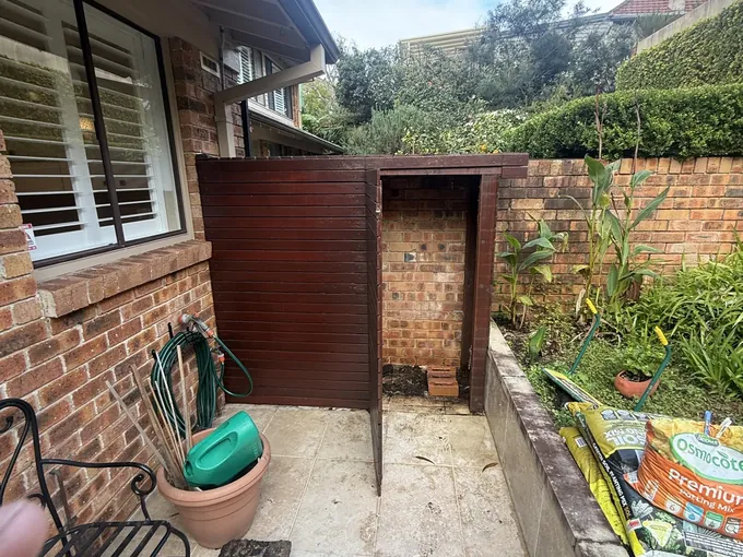 Empty outdoor recess beside a Cremorne home where the old hot water system stood
