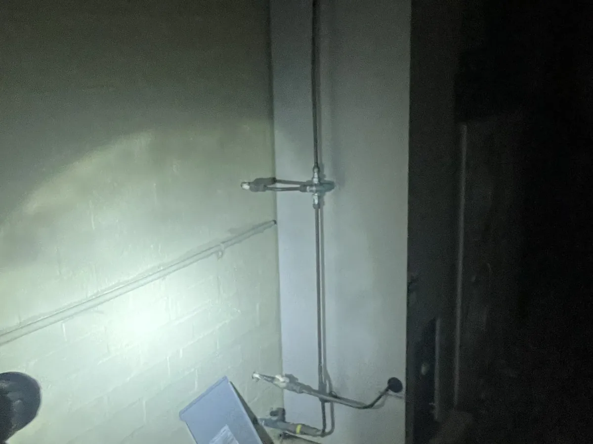 Hot water system checked by torchlight at night