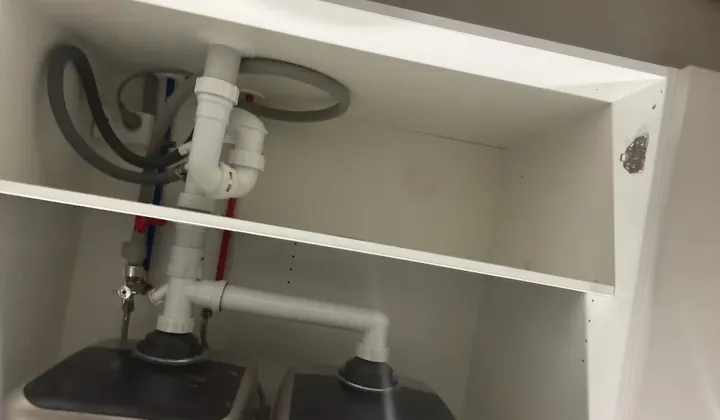 Waste pipes and traps under a kitchen sink in Blacktown