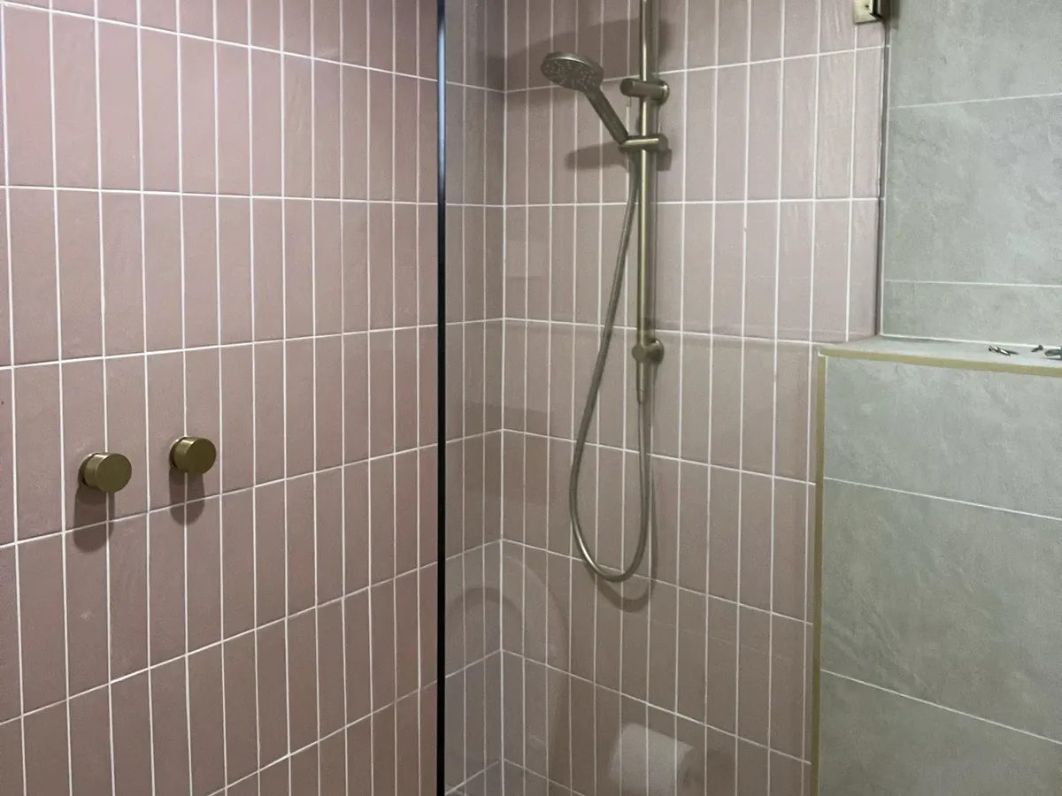 Walk-in shower with a slow floor drain in Strathfield