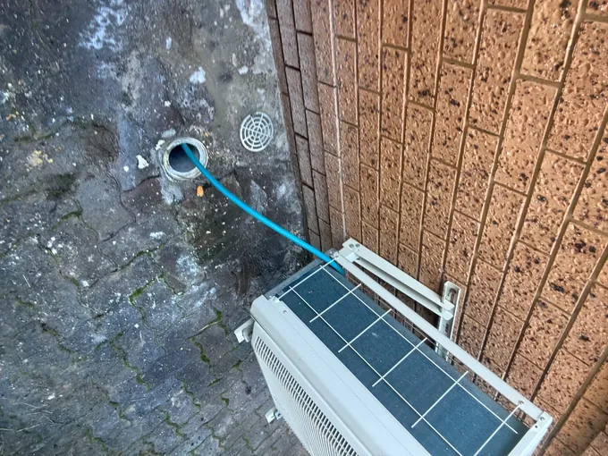 Hose fed into the blocked kitchen waste pipe outside a house in Bossley Park