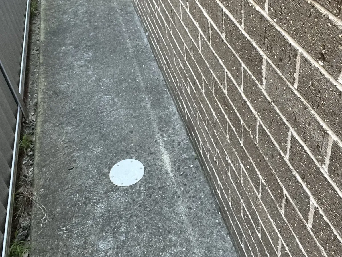 Sewer inspection cap set into the concrete side path of a house in Mount Druitt