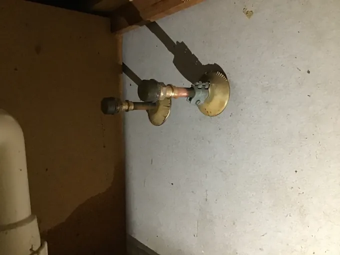 Capped brass fittings on the copper water pipes at the back of a kitchen cupboard in Greenfield Park