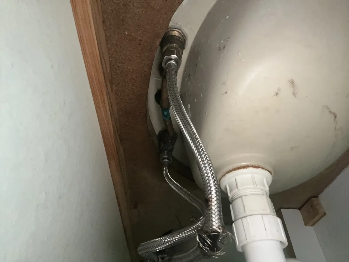 Burst braided flexi hose with frayed wires under a basin in Wetherill Park