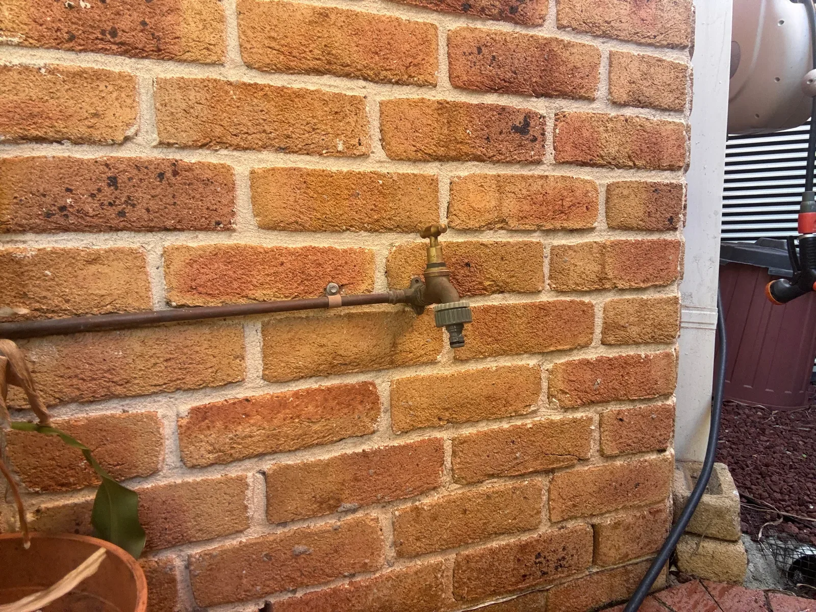 Outdoor tap on a brick wall serviced on a Mr Splash job in Castle Hill
