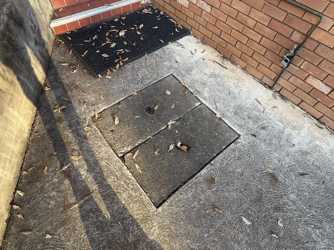 Drain access pit lids in the concrete yard of a business in Quakers Hill