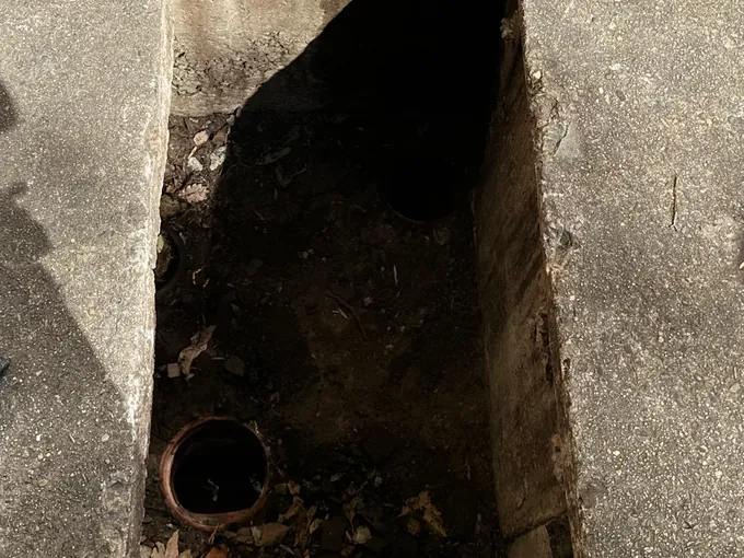 Old clay drain pipe exposed in a dug-out section between concrete slabs in Quakers Hill