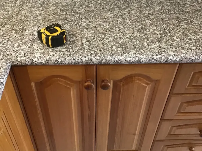 Tape measure on a granite benchtop above the cupboards being measured up in East Hills