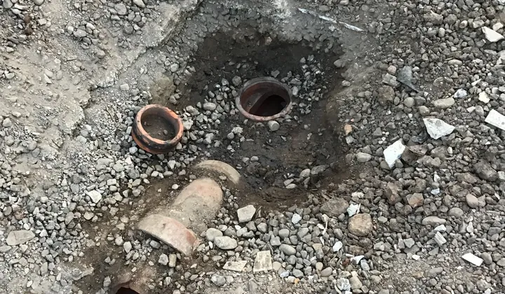 Broken clay drain pipe and old sockets dug out of the gravel in Castle Hill