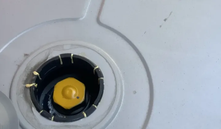 Cover off the top of a hot water tank with the fitting underneath exposed in Blacktown