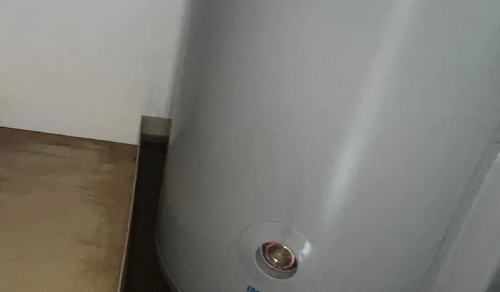 Electric hot water tank standing in a safe tray inside a cupboard in Randwick