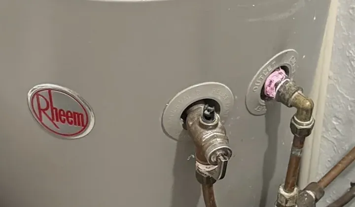 Rheem electric hot water tank with its relief valve and hot water outlet pipes in Bankstown