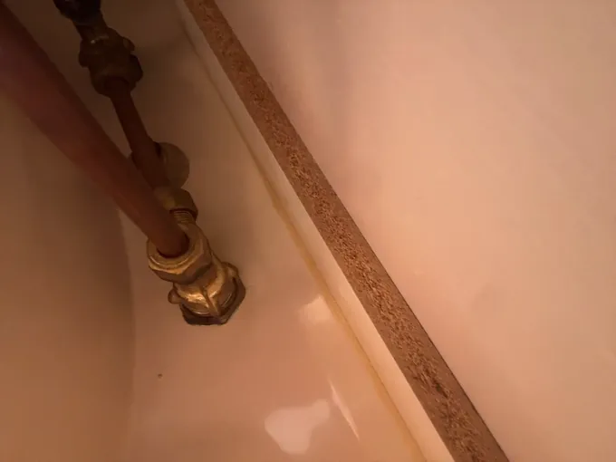 Old brass tap fitting above a bath in a Kingsgrove bathroom