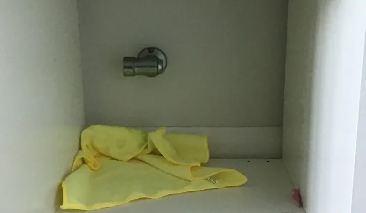 Gas bayonet on the back wall of a white shelving cubby above a carpeted floor in Kellyville