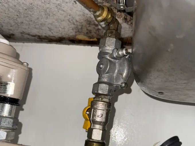 Gas fitting, yellow isolation valve and copper gas line at the supply in Parramatta