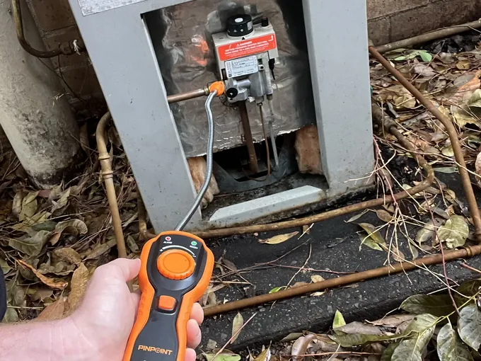 Gas leak detector probe held at a gas control valve while the joints are tested in Cremorne