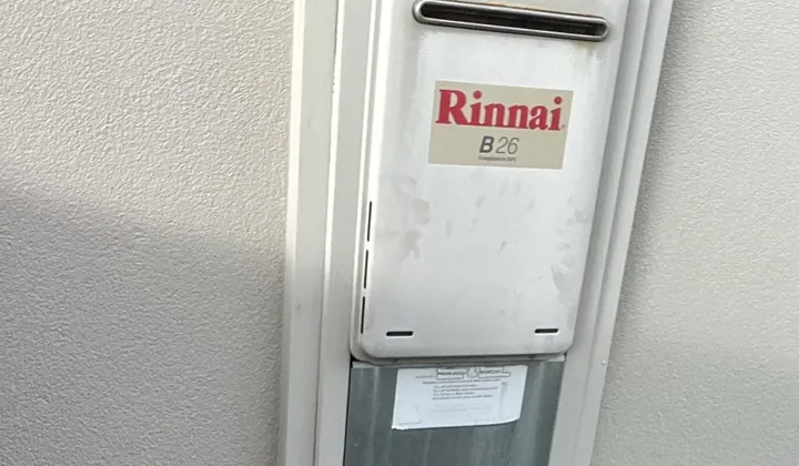 Continuous flow gas hot water unit fitted in a recess box on a rendered wall in Kellyville