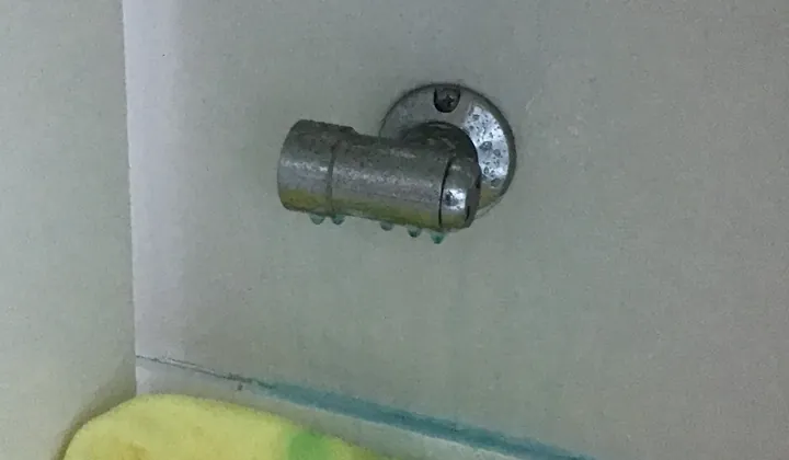 Close view of a gas bayonet fitting on a white wall above a yellow cloth in Kellyville