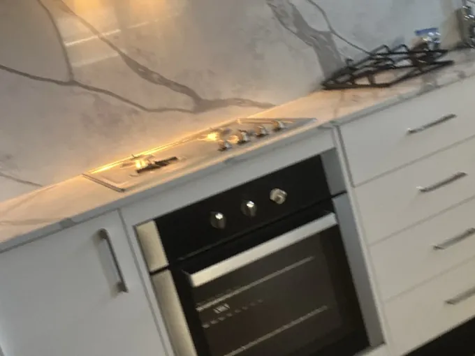 Gas cooktop and under bench oven connected in a finished kitchen in Spring Farm