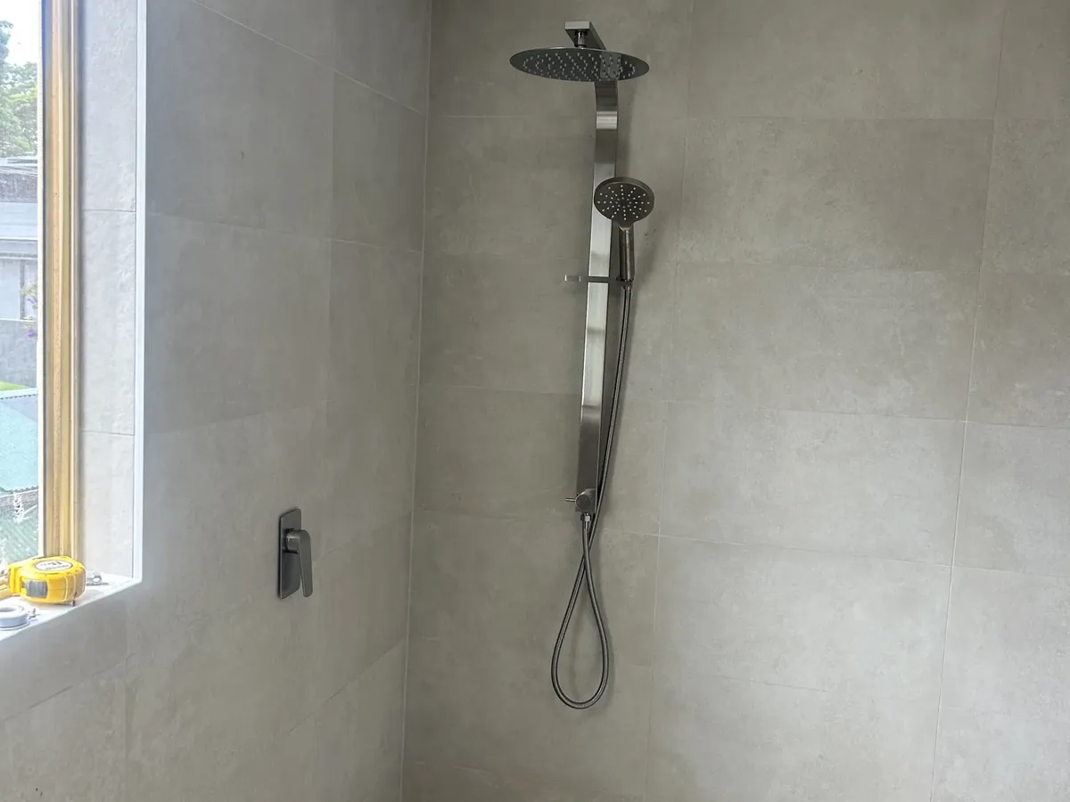 Newly tiled shower with a rail shower fitted in a Kingsgrove bathroom