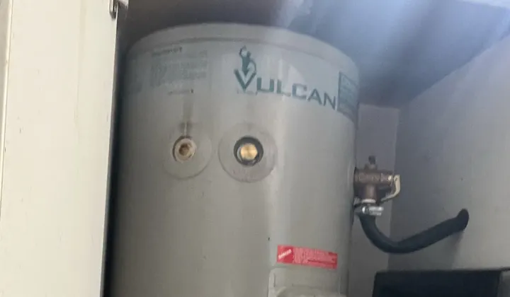 Vulcan electric storage tank and its relief valve inside a cupboard in Dulwich Hill