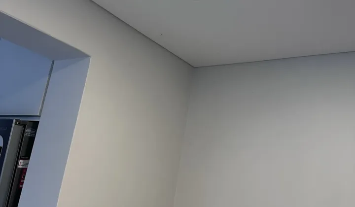 Water stain on a ceiling below a leaking hot water system in an apartment