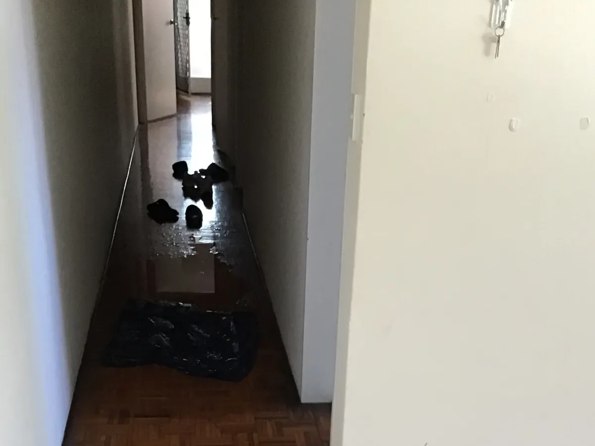 Water from a leaking hot water tank spread across the timber floor of a Campsie unit