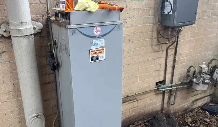 Older Rheem gas storage hot water system outside beside a continuous flow unit