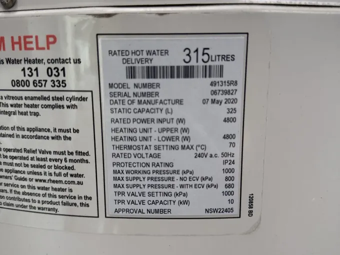 Data plate on a Rheem electric water heater showing 315 litres rated delivery