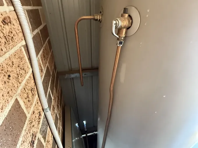 Relief valve and copper drain pipe on an electric hot water tank