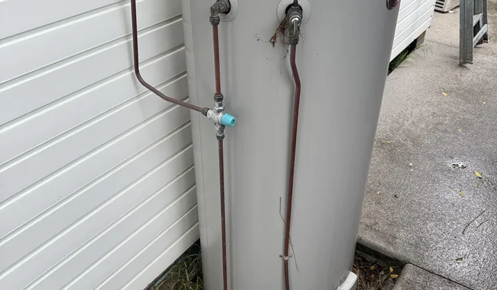 Rheem electric hot water system labelled 315 litres outside a house