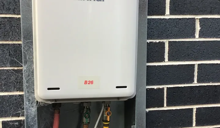 Rinnai B26 continuous flow gas hot water unit on a brick wall