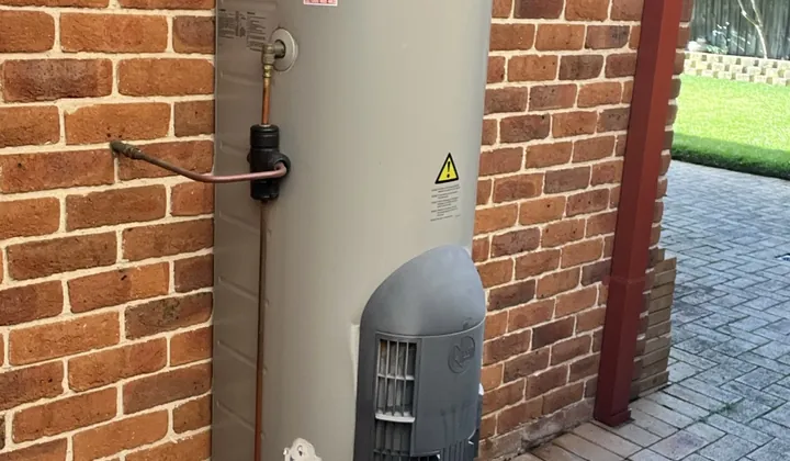 Rheem Stellar gas storage hot water system against a brick wall