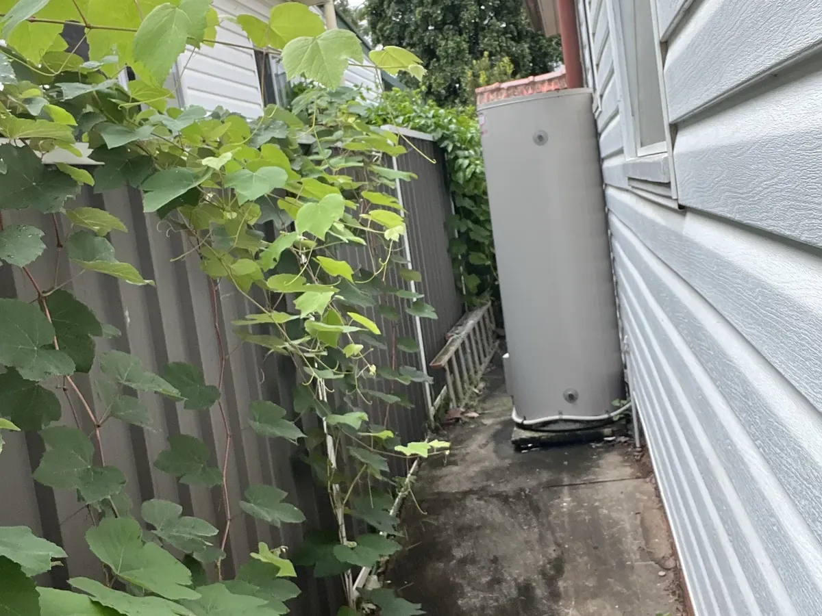 Electric storage hot water system at the end of a narrow side path