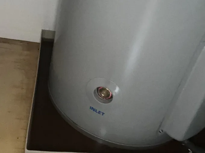 Electric hot water tank standing in a safe tray inside a cupboard in Randwick