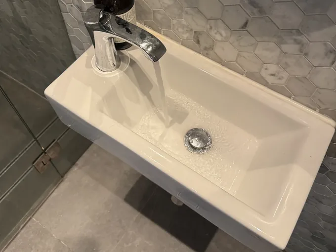 Water running from the basin mixer in a Glebe bathroom