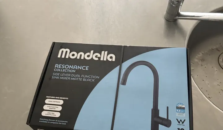 New boxed kitchen mixer tap on the bench beside the old tap in Surry Hills
