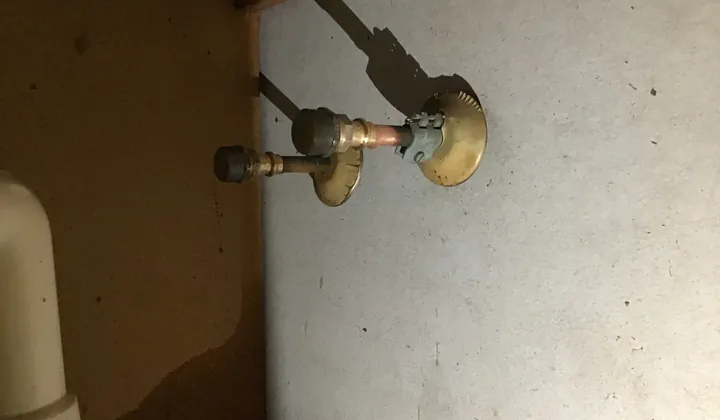 Capped brass fittings on the copper water pipes at the back of a kitchen cupboard in Greenfield Park