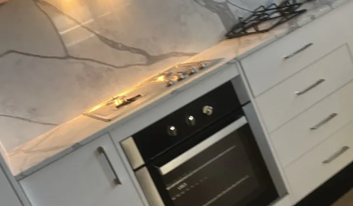 Gas cooktop and under bench oven connected in a finished kitchen in Spring Farm
