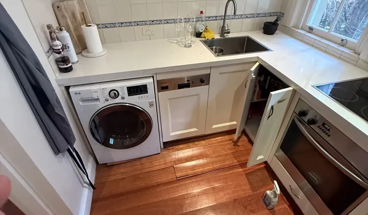 Front-loading washing machine built into kitchen cabinetry