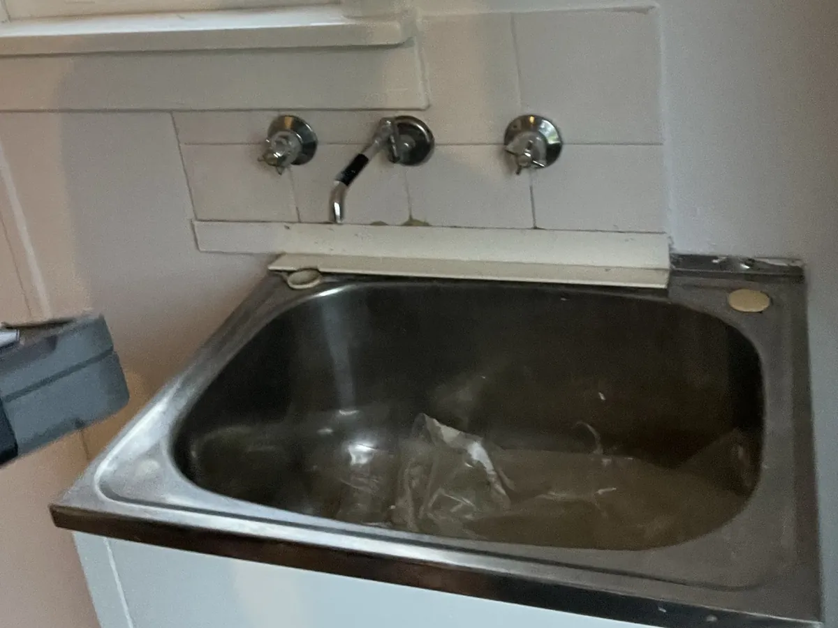 Old stainless laundry tub and wall taps in Lalor Park