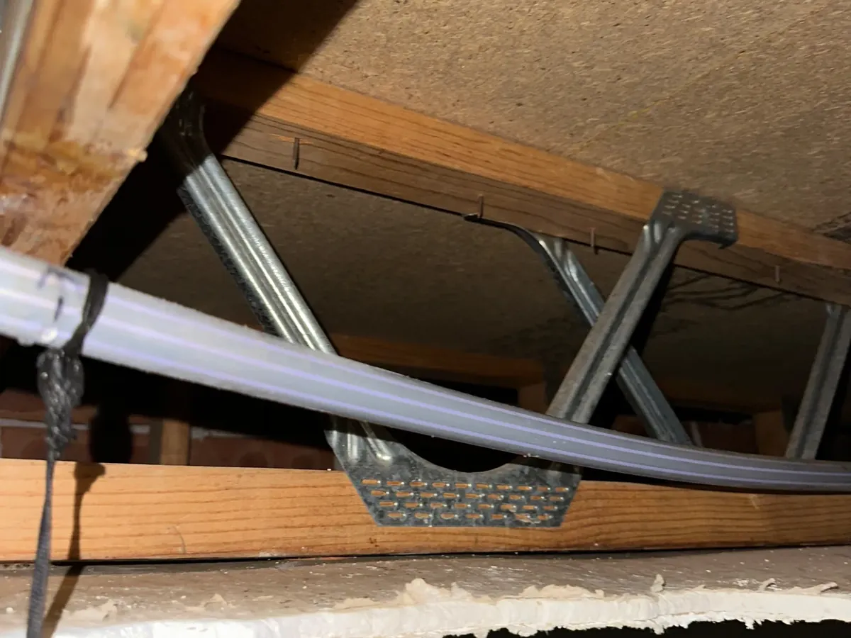 Water pipe exposed through an opened ceiling above a window in Glenwood