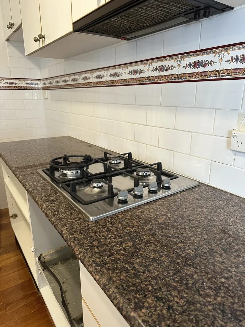 Gas cooktop in a stone benchtop repaired and reconnected by a Mr Splash gas fitter in Marrickville
