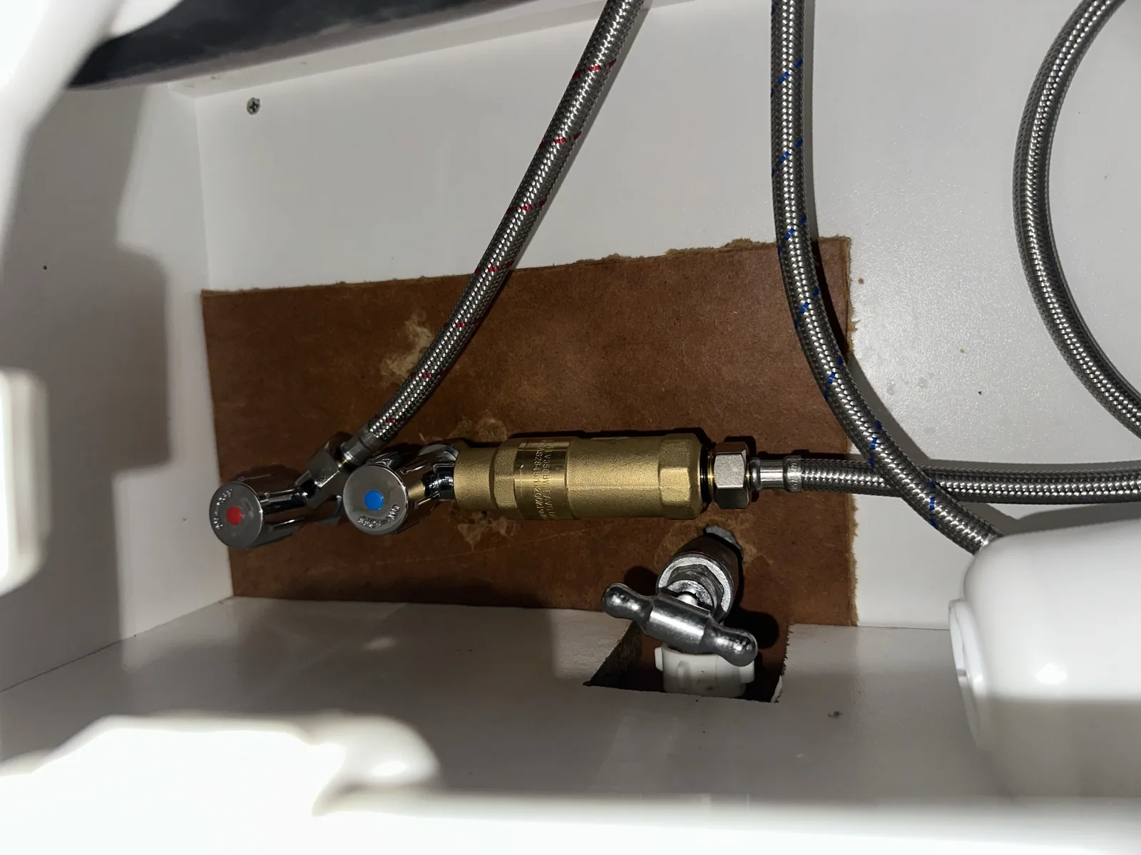 New isolation valves and flexible hoses fitted under a kitchen sink after a burst on a Mr Splash emergency job in Mortdale