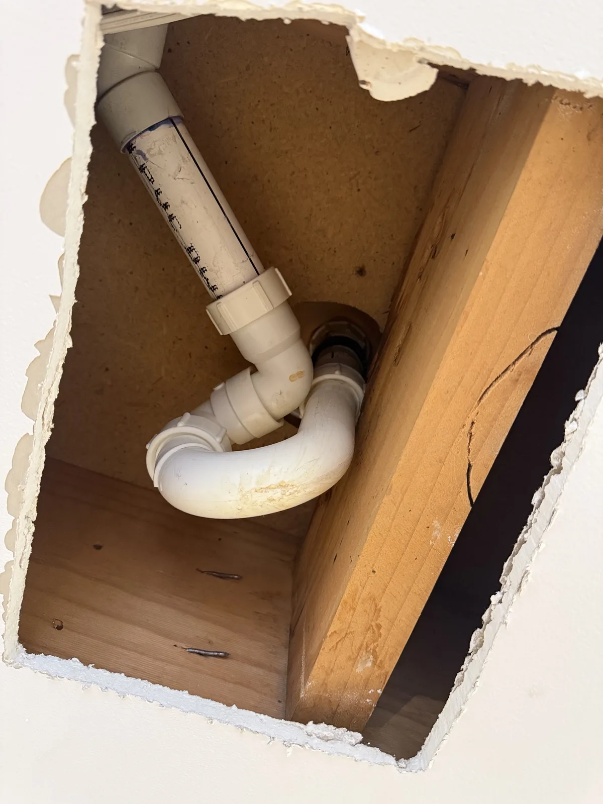 Ceiling opened to reach a leaking bath waste pipe on a Mr Splash emergency job in Pendle Hill
