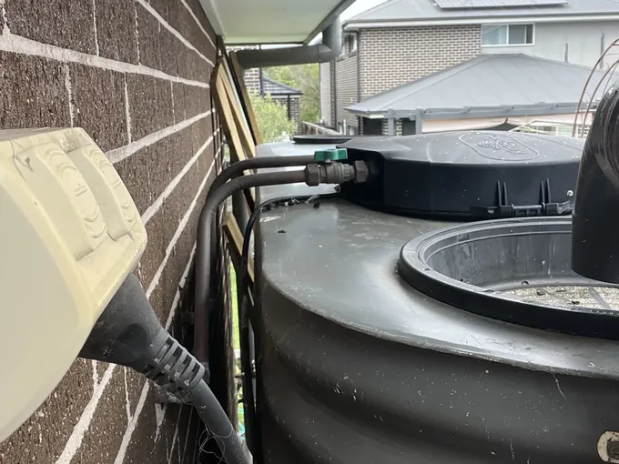 Outlet valve and pipework on top of a rainwater tank in Marsden Park