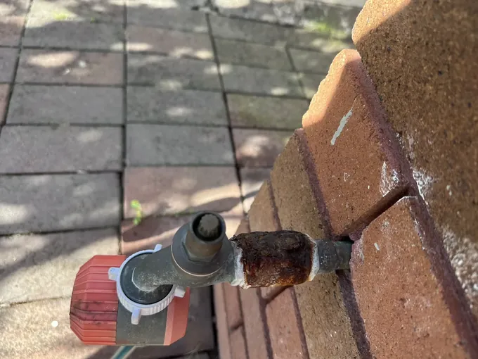Rusted fitting behind an outdoor tap in Westmead